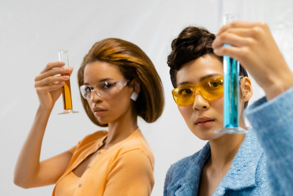 Two women scientists analyzing liquid samples in a modern laboratory setting.